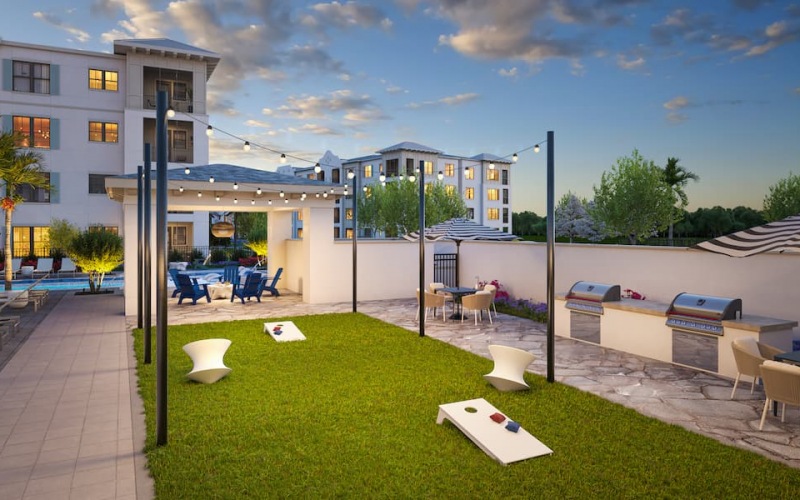 rendering of courtyard showing corn-hole, landscaping and modern seating